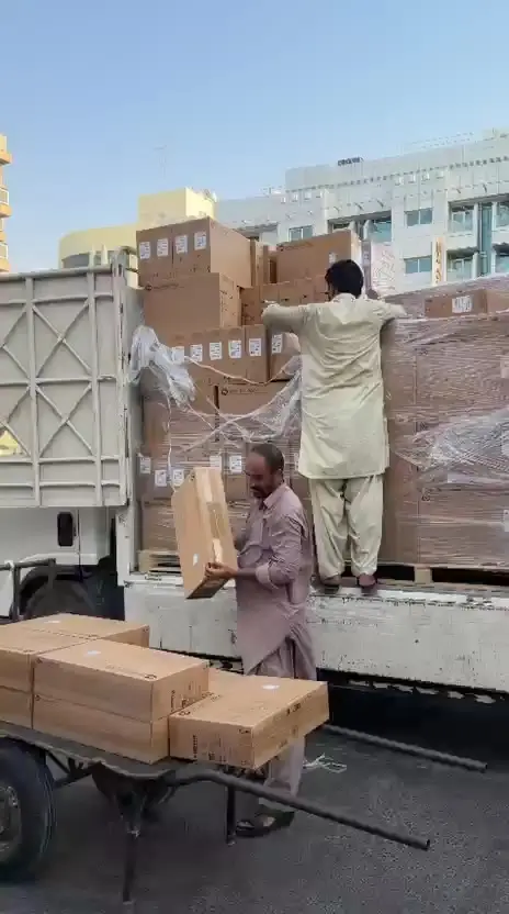 A wrapped pallet of IT hardware being unloaded.